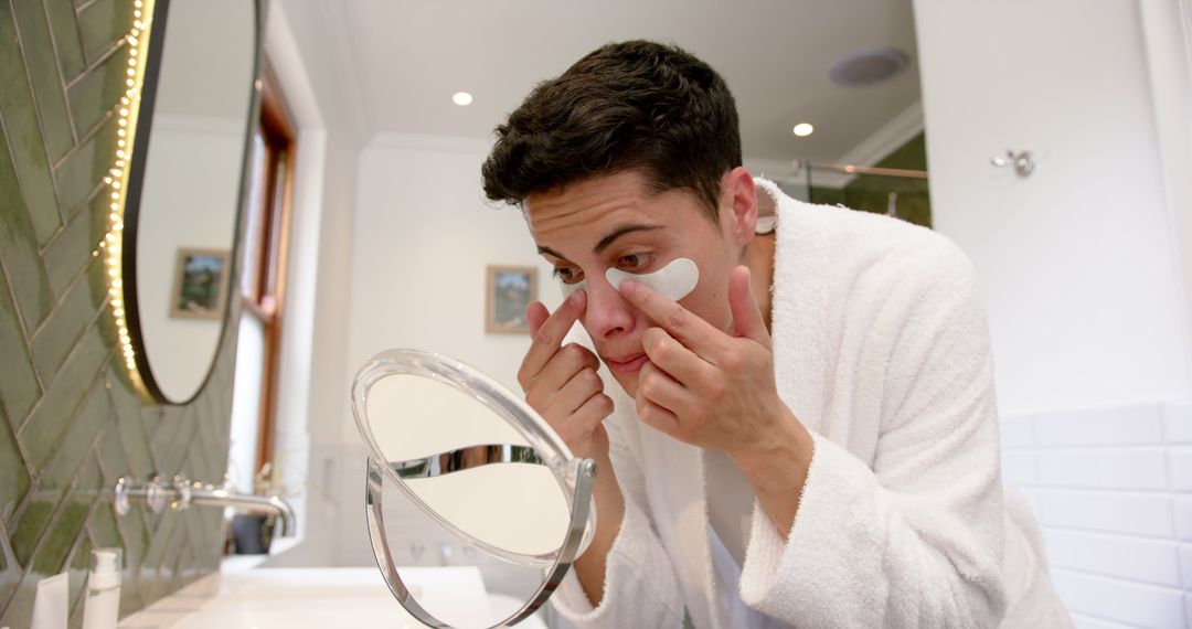 Young Man Applying Under Eye Masks for Skincare Routine