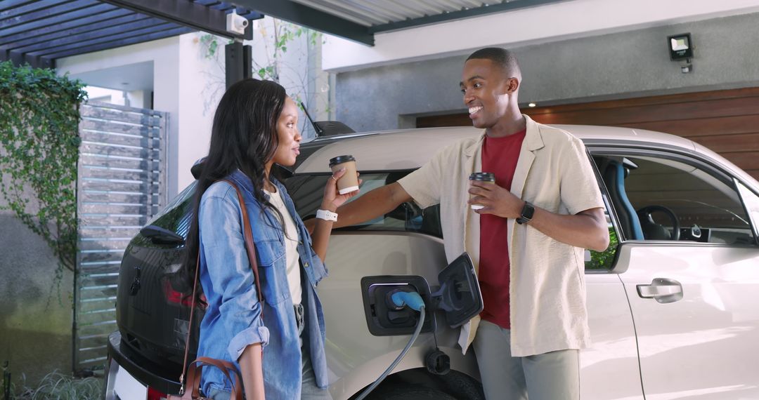 Couple Enjoying Coffee While Charging Electric Car at Home