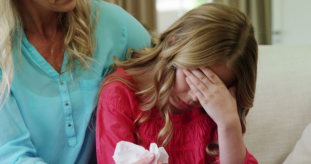 Upset Young Girl Comforted by Mother on Couch - Free Images, Stock Photos and Pictures on Pikwizard.com