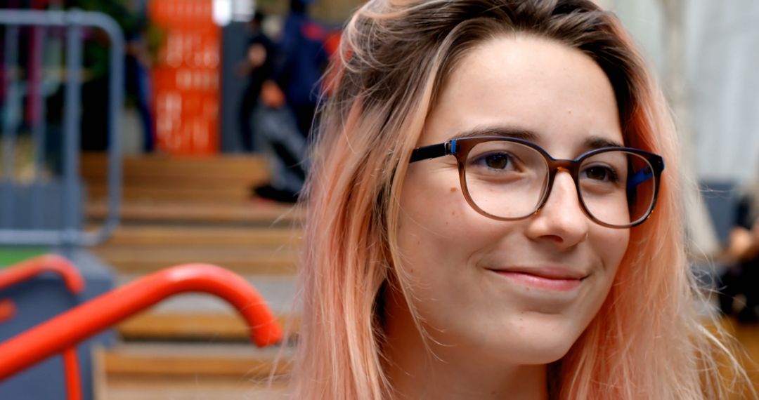 Smiling Young Woman with Glasses in Urban Environment - Free Images, Stock Photos and Pictures on Pikwizard.com