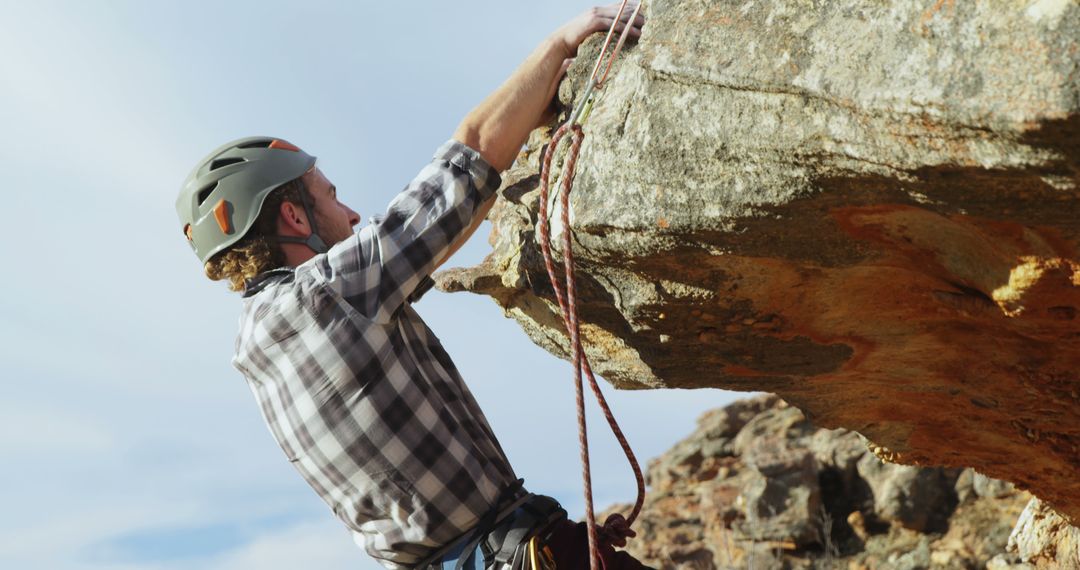 Male Rock Climber Ascending Cliff with Safety Gear - Free Images, Stock Photos and Pictures on Pikwizard.com