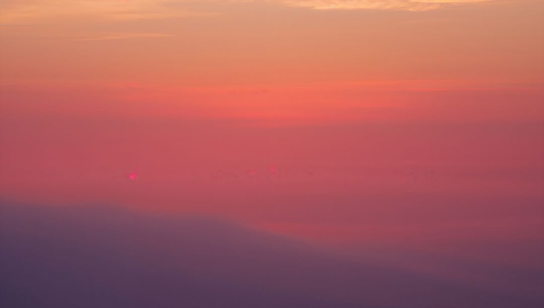 Vibrant Sky Gradient Above Clouds at High Altitude
