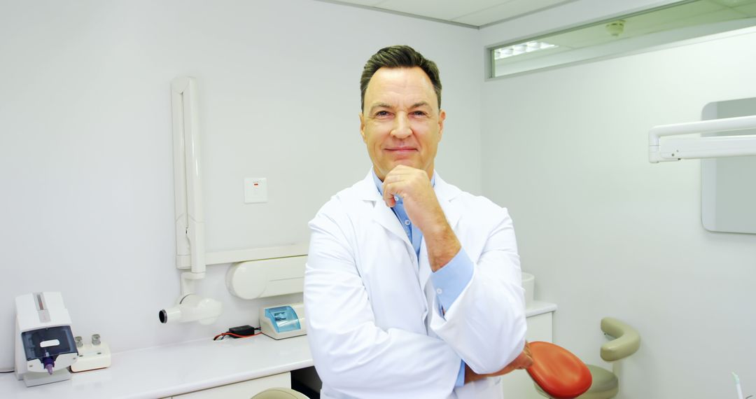 Confident Male Dentist Standing in Modern Dental Office - Free Images, Stock Photos and Pictures on Pikwizard.com