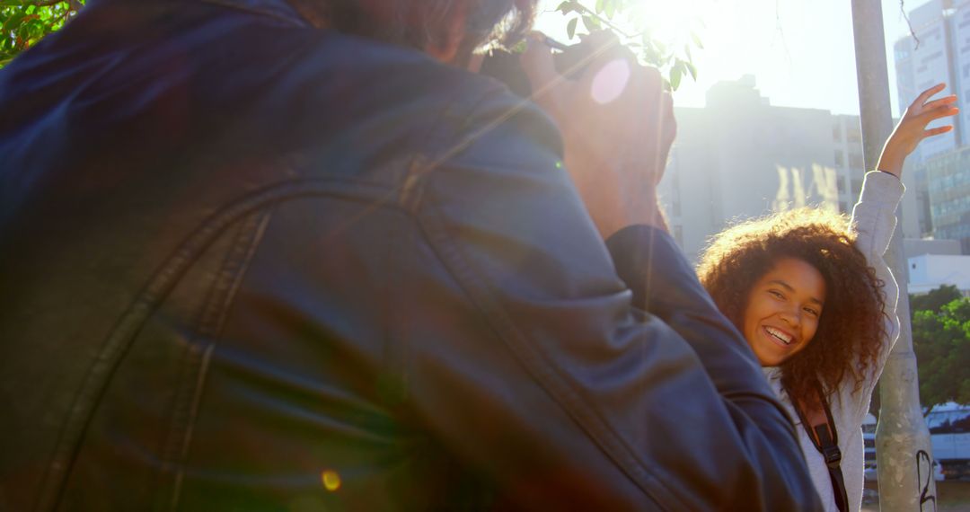 Photographer Capturing Smiling Woman Posing Outdoors - Free Images, Stock Photos and Pictures on Pikwizard.com