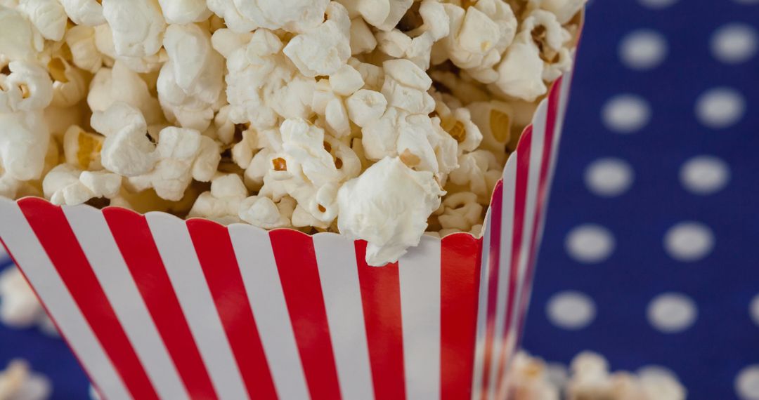 Festive Popcorn in Striped Box with Polka Dot Background - Free Images, Stock Photos and Pictures on Pikwizard.com