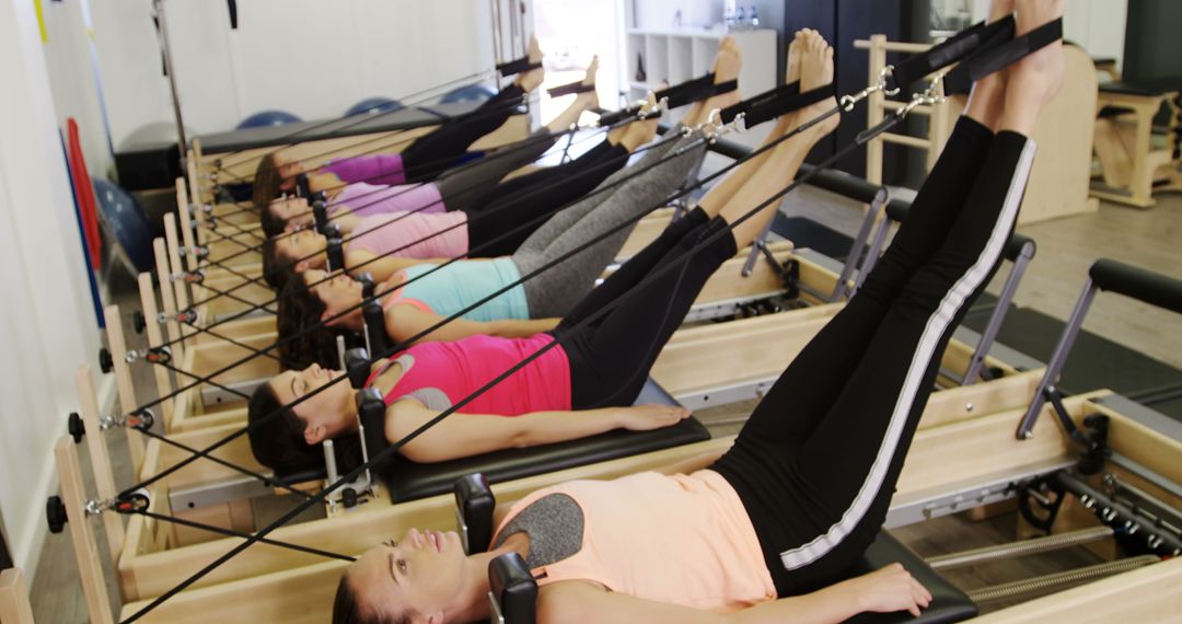 Women practicing Pilates reformer exercises in class - Free Images, Stock Photos and Pictures on Pikwizard.com