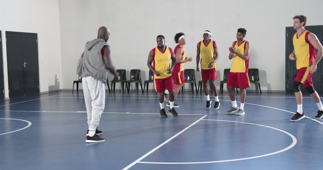 Dynamic Basketball Team Training Session with Coach Guidance