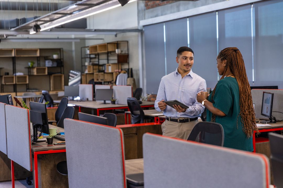 Diverse Coworkers Discussing Project in Modern Open-Plan Office