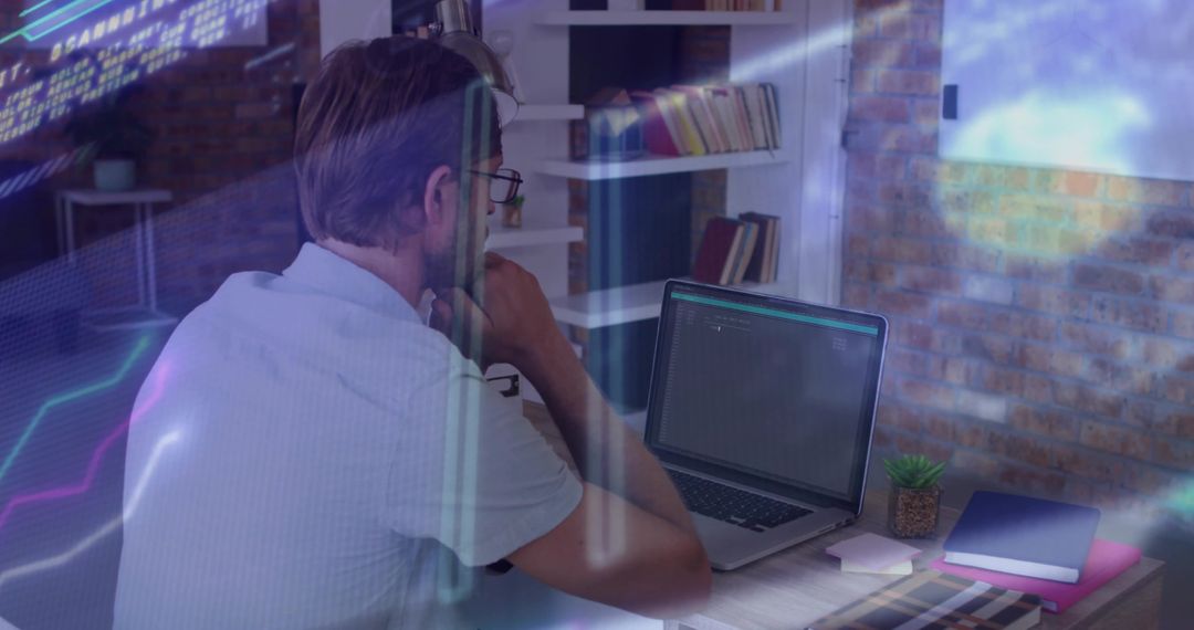 Middle-aged man working on laptop with futuristic data overlays in office analyzing charts