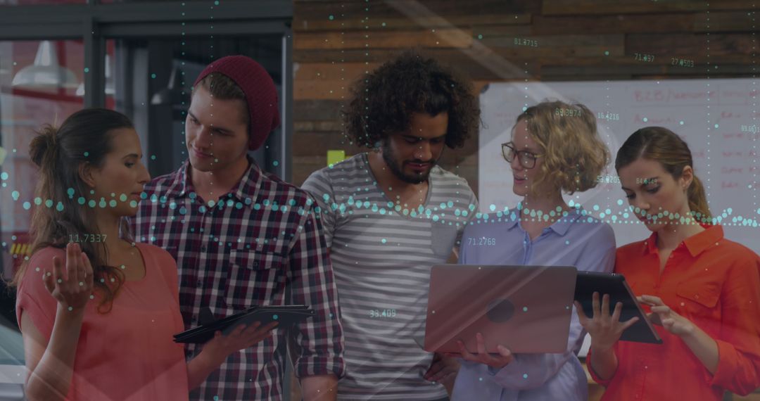 Diverse Team Collaborating in Modern Office with Digital Graphs