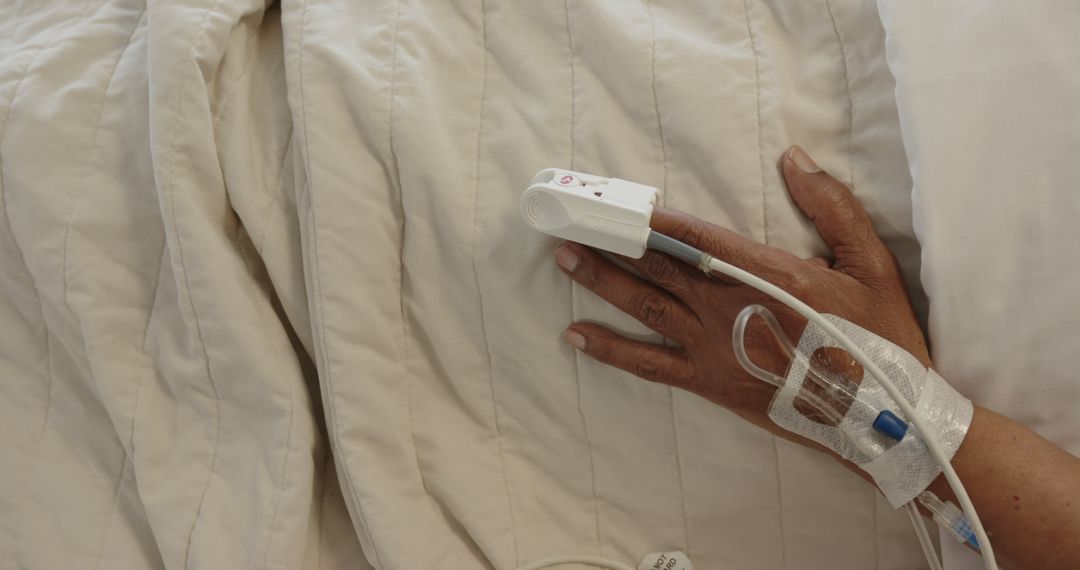 Closeup of Patient Hand with IV Drip and Finger Pulse Oximeter in Hospital Bed - Free Images, Stock Photos and Pictures on Pikwizard.com