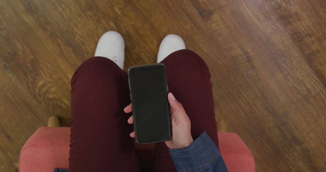 Person Sitting on Chair Holding Smartphone with Blank Screen - Free Images, Stock Photos and Pictures on Pikwizard.com