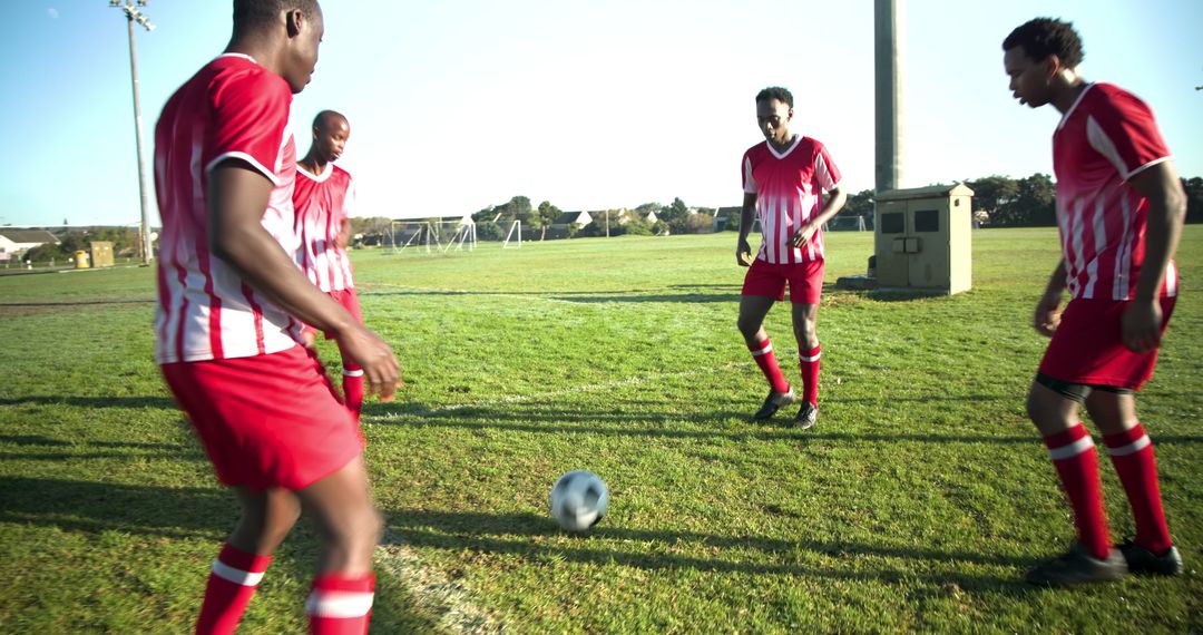 Teammates Strategizing on Soccer Field, Ready for Play