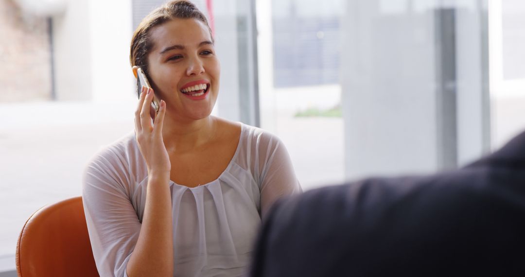 Businesswoman Discussing Over Mobile Phone in Modern Office Environment