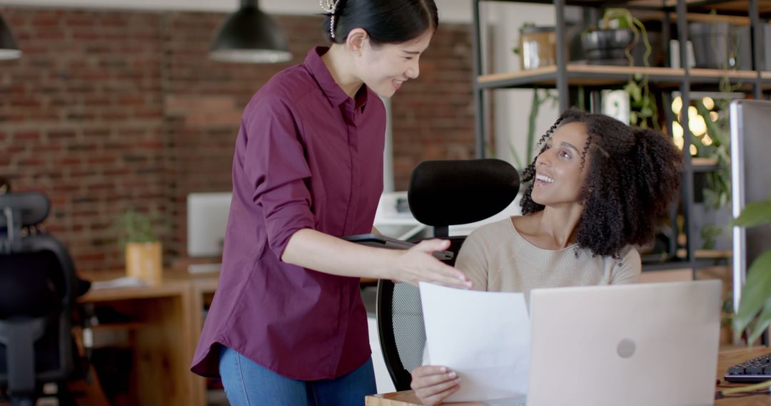 Two Female Colleagues Discussing Work in Modern Office Loft - Free Images, Stock Photos and Pictures on Pikwizard.com