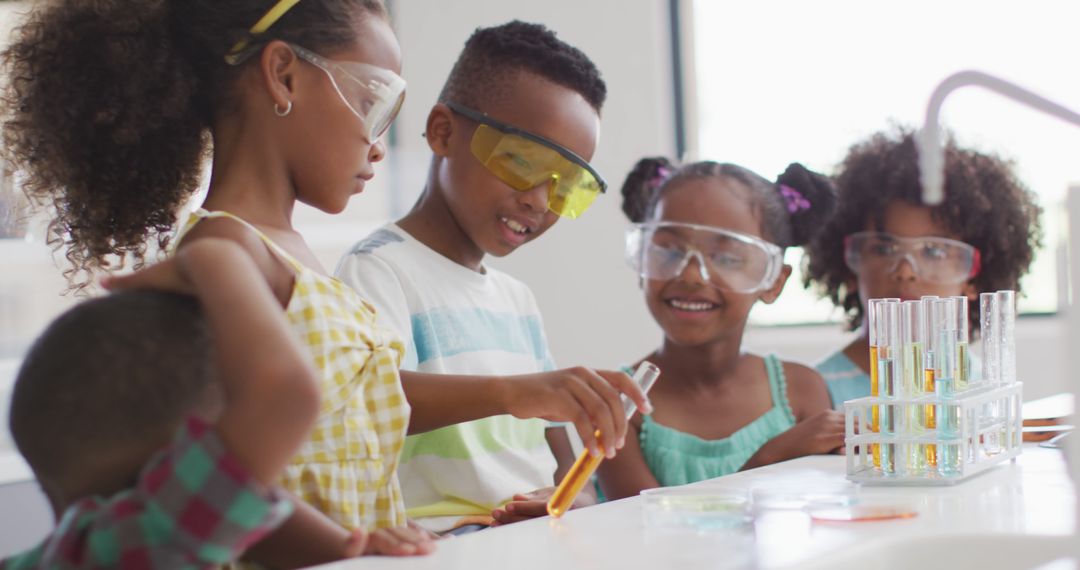 Image of happy african american pupils doing experiment during chemistry lesson - Free Images, Stock Photos and Pictures on Pikwizard.com