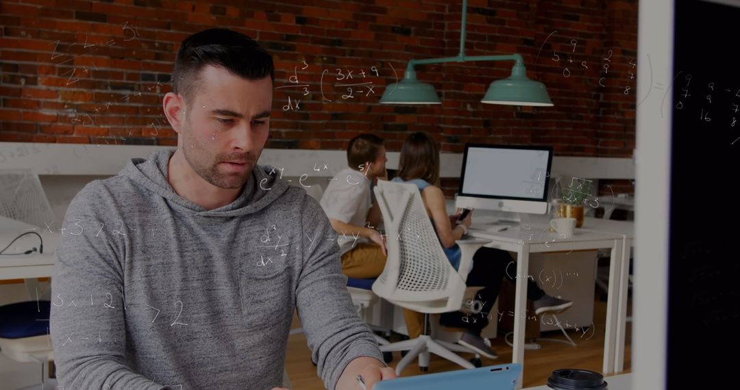 Focused Man Concentrating on Laptop with Mathematical Formulas