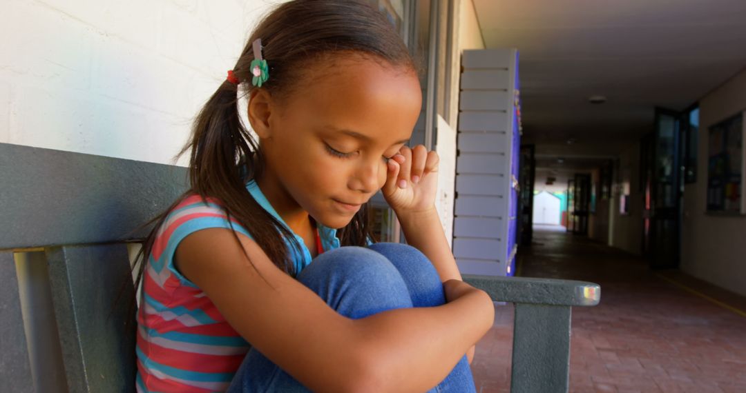 Sad African American Girl Crying on School Bench
