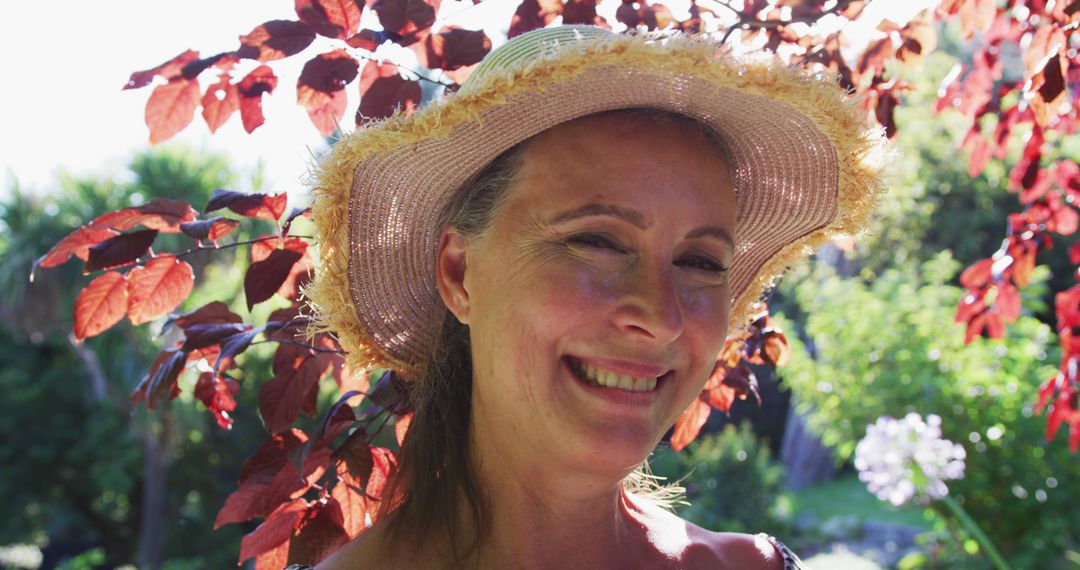 Portrait of happy caucasian senior woman in garden wearing sunhat and smiling in the sun - Free Images, Stock Photos and Pictures on Pikwizard.com