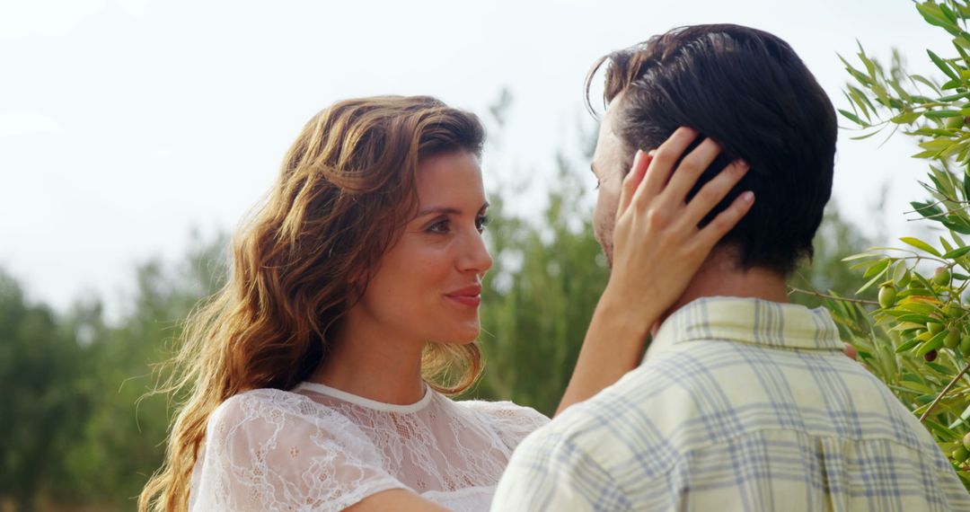 A couple shares a tender, romantic moment in nature. - Free Images, Stock Photos and Pictures on Pikwizard.com