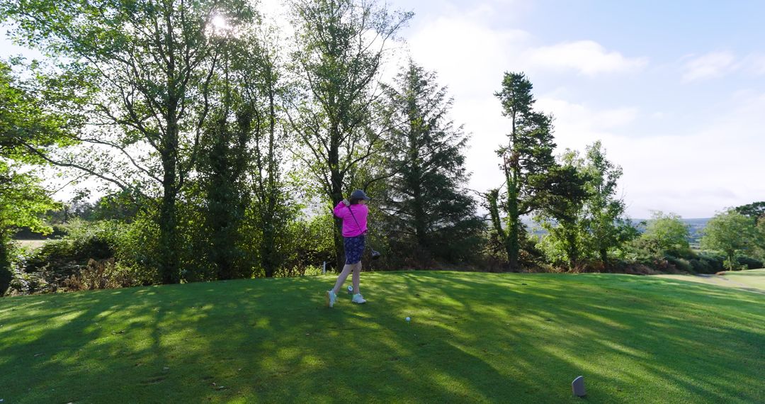 Senior Golfer Swinging on Relaxing Golf Course