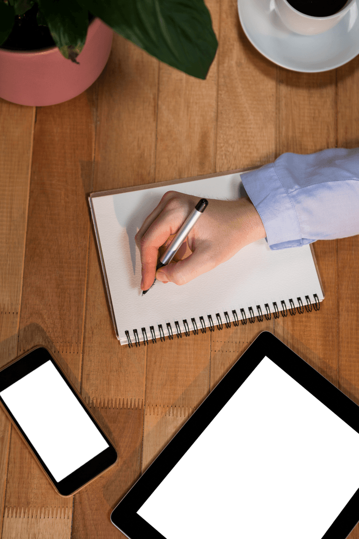 Transparent View of Businessman's Hand Writing in Office Setting