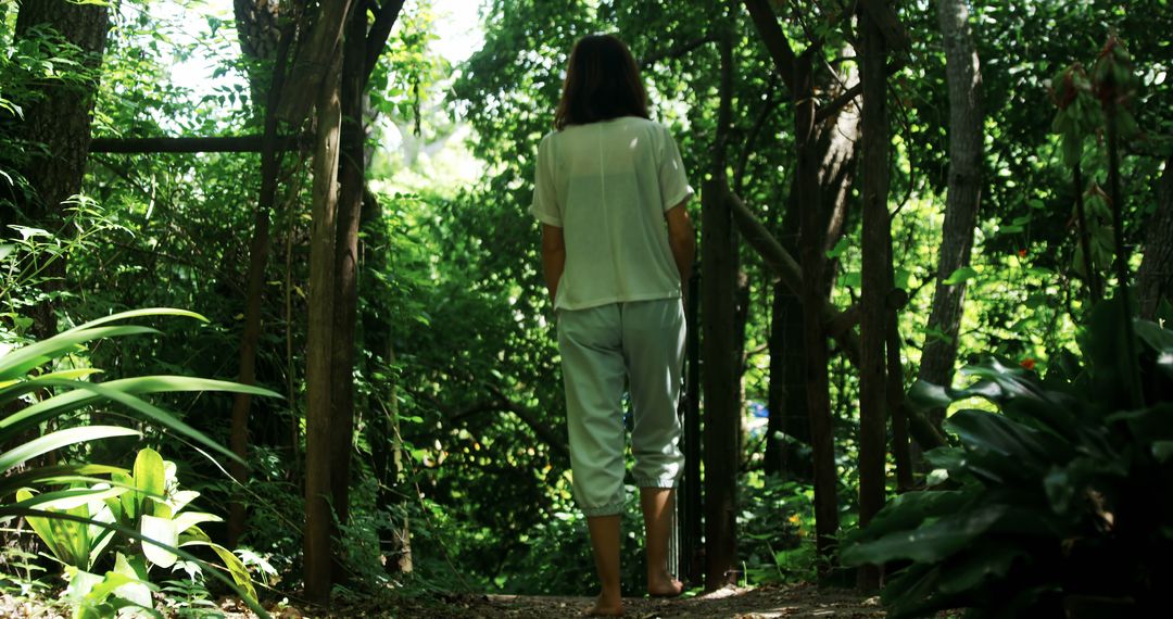 Caucasian Woman Walking Peacefully in Lush Forest Atmosphere - Free Images, Stock Photos and Pictures on Pikwizard.com