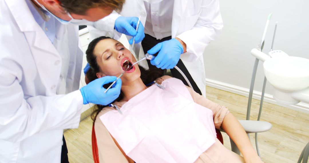 Dental Professionals Treating Female Patient with Open Mouth - Free Images, Stock Photos and Pictures on Pikwizard.com