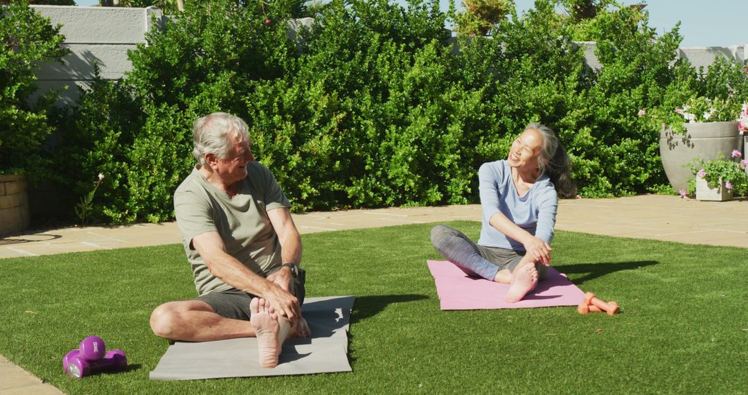 Seniors Stretching Outdoors on Mats in Sunny Garden - Free Images, Stock Photos and Pictures on Pikwizard.com