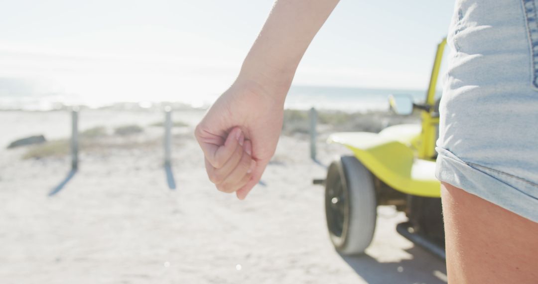 Close-Up of Person's Hand and Beach Buggy Near Seaside - Free Images, Stock Photos and Pictures on Pikwizard.com