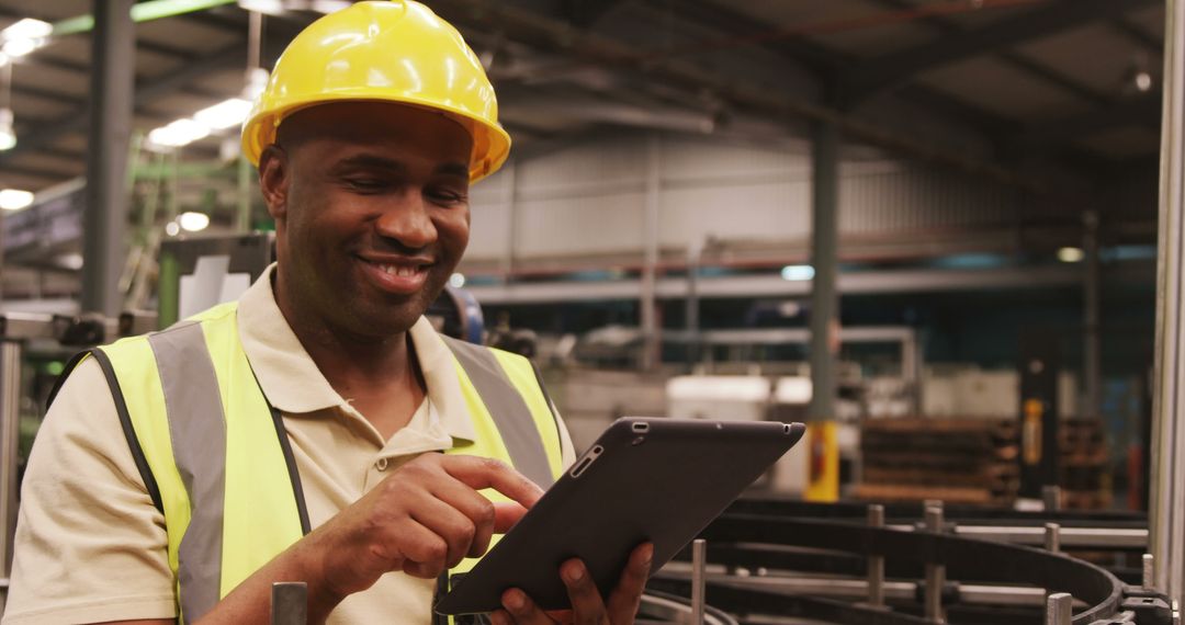 Engineer in Hard Hat Using Tablet in Industrial Factory - Free Images, Stock Photos and Pictures on Pikwizard.com