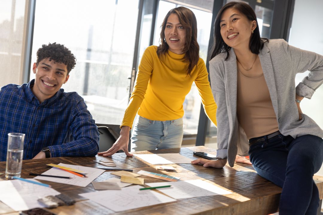 Diverse Team Collaborating at Office with Design Sketches