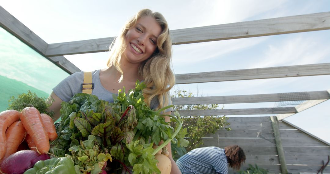 Smiling Woman Harvesting Fresh Organic Vegetables in Garden - Free Images, Stock Photos and Pictures on Pikwizard.com