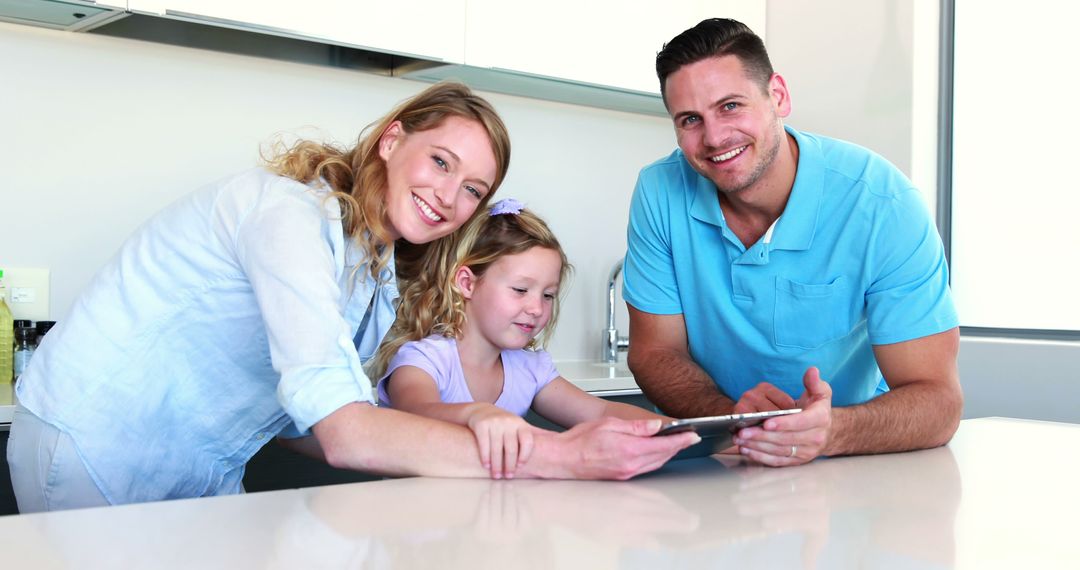 Happy Family Using Tablet in Modern Kitchen - Free Images, Stock Photos and Pictures on Pikwizard.com