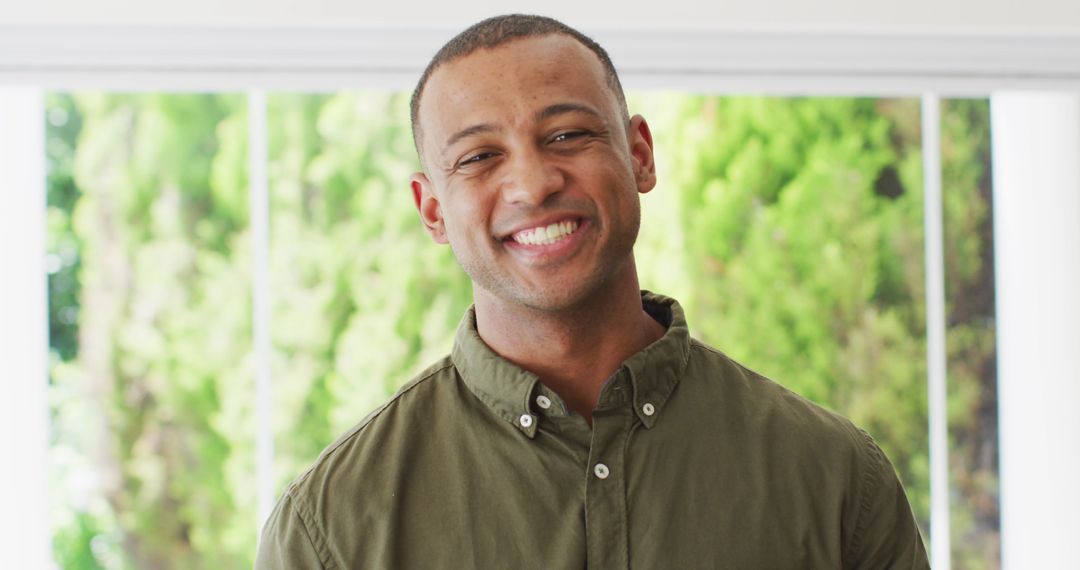 Happy Man Smiling Indoors with Natural Light