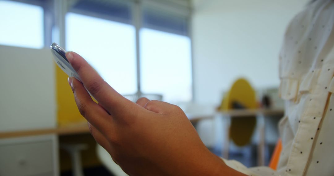 A person is holding a smartphone in a classroom setting, with copy space - Free Images, Stock Photos and Pictures on Pikwizard.com