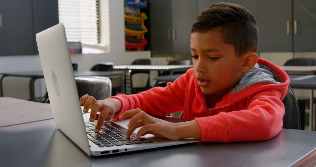 Focused Child Learning on Laptop in Classroom