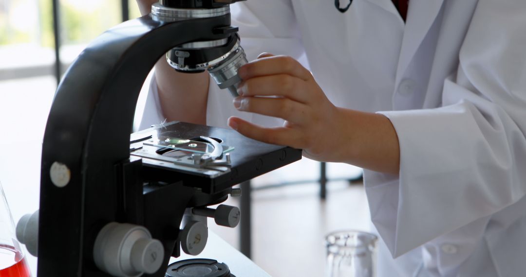 Scientist Analyzing Samples Through Microscope in Laboratory - Free Images, Stock Photos and Pictures on Pikwizard.com