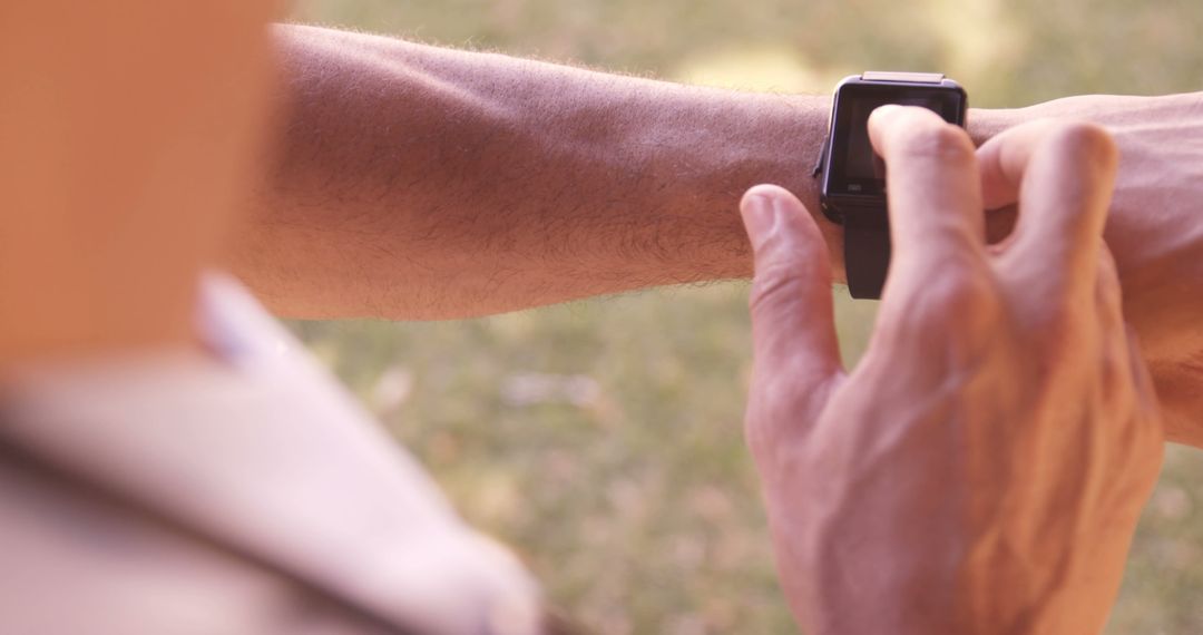 Close-up of Person Wearing and Using a Smartwatch Outdoors - Free Images, Stock Photos and Pictures on Pikwizard.com