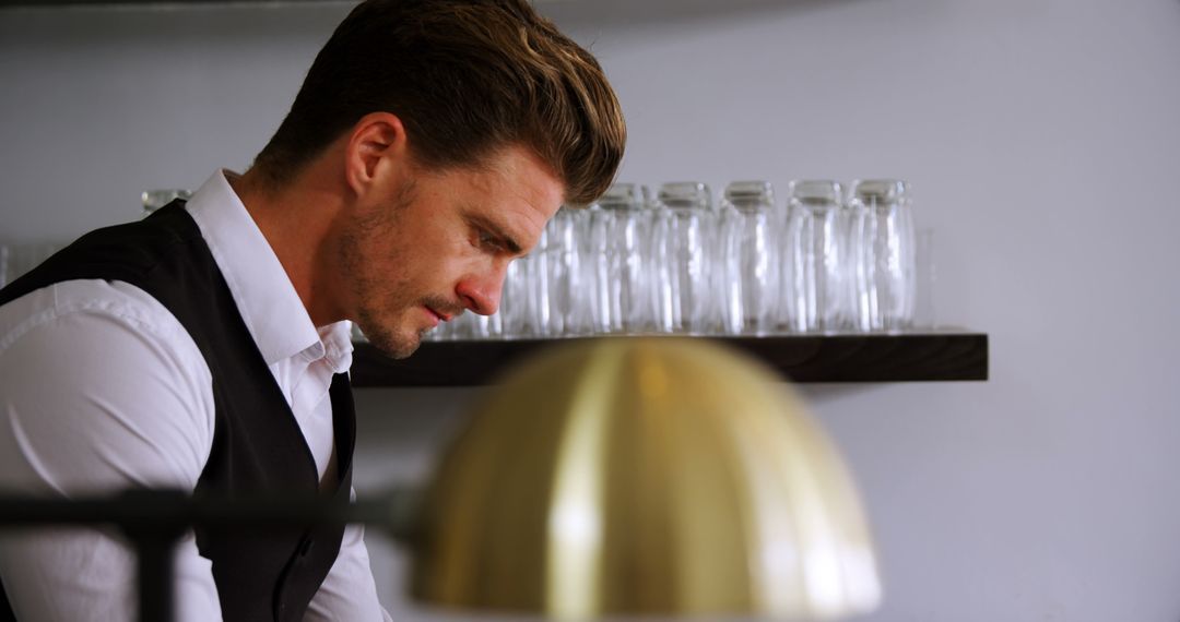 Focused Waiter Preparing Order in Upscale Restaurant
