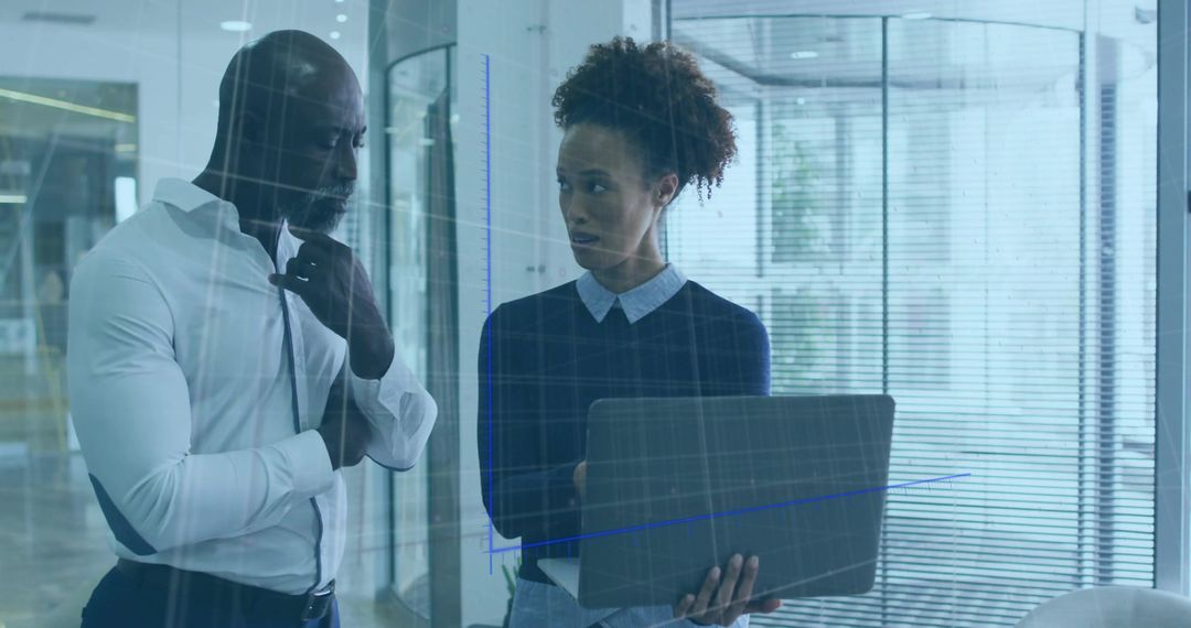 Professionals Analyzing Data in Modern Office with Glass Grid Partition