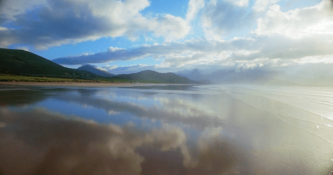 Transparent Reflections on Beach with Dramatic Cloudy Sky