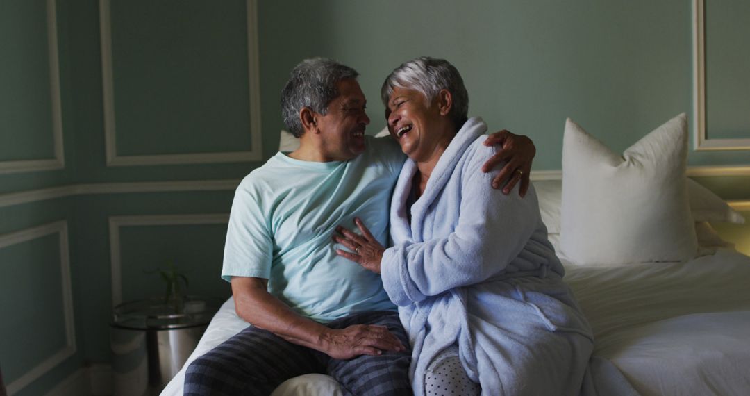 Happy Senior Couple Embracing on Bed at Home