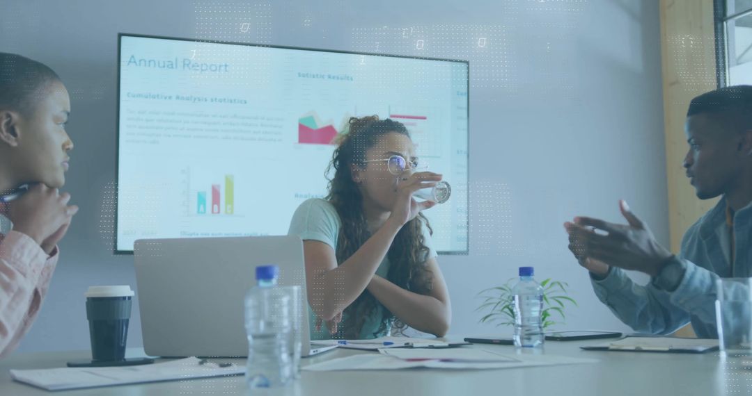 Diverse Team Collaborating While Analyzing Reports in Modern Conference Room