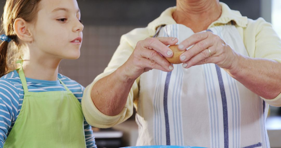 Grandmother Teaching Granddaughter to Cook in Kitchen - Free Images, Stock Photos and Pictures on Pikwizard.com