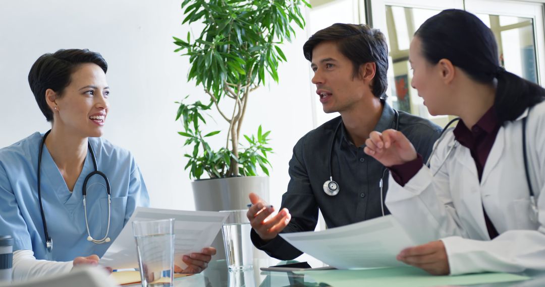 Multiracial Medical Professionals Discussing Documents in Bright Office - Free Images, Stock Photos and Pictures on Pikwizard.com