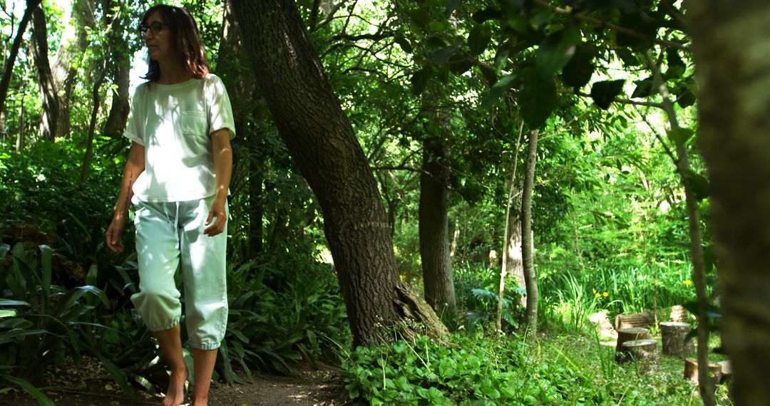 Woman Strolling in Lush Green Forest Trail - Free Images, Stock Photos and Pictures on Pikwizard.com