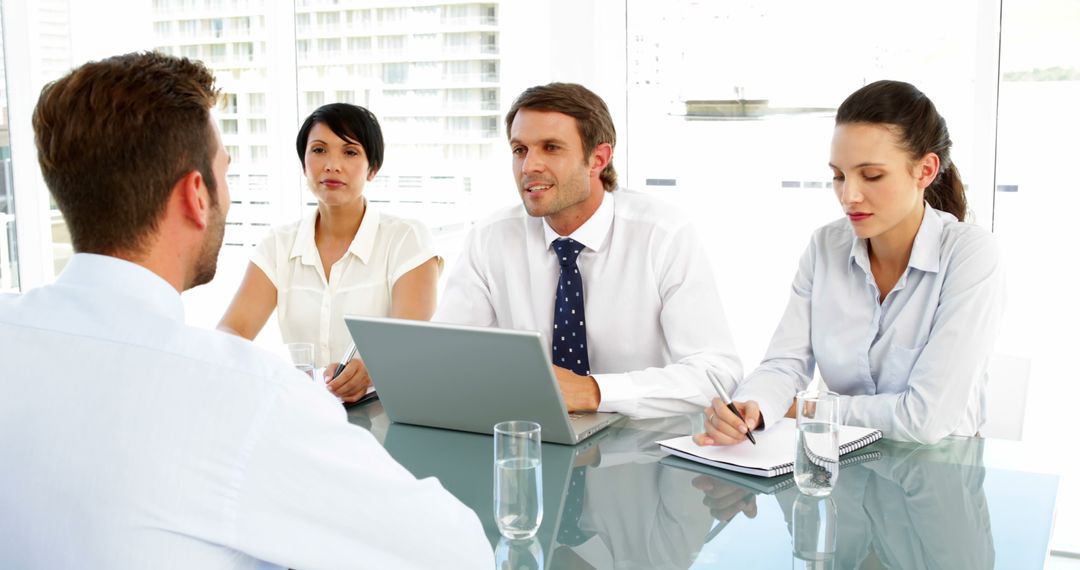 Professional Interview Panel Engaging with Applicant in Modern Office