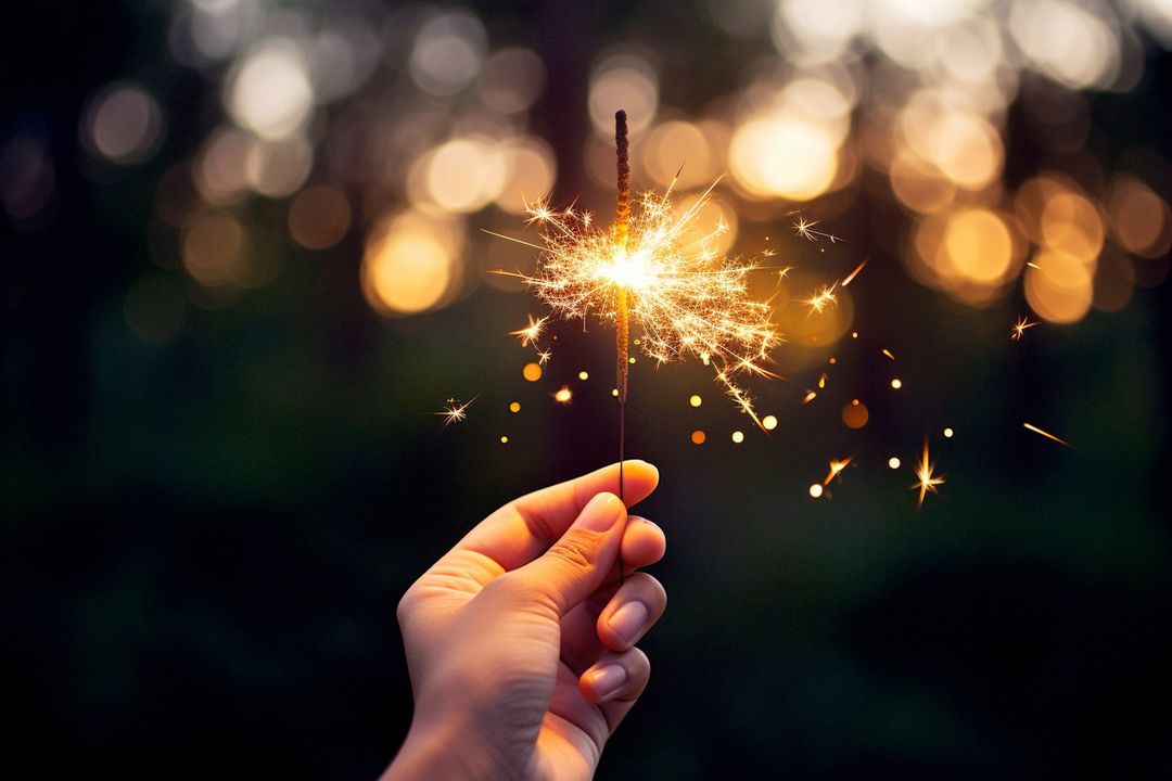 Hand Holding Sparkler Creating Magical Sparkle Effect