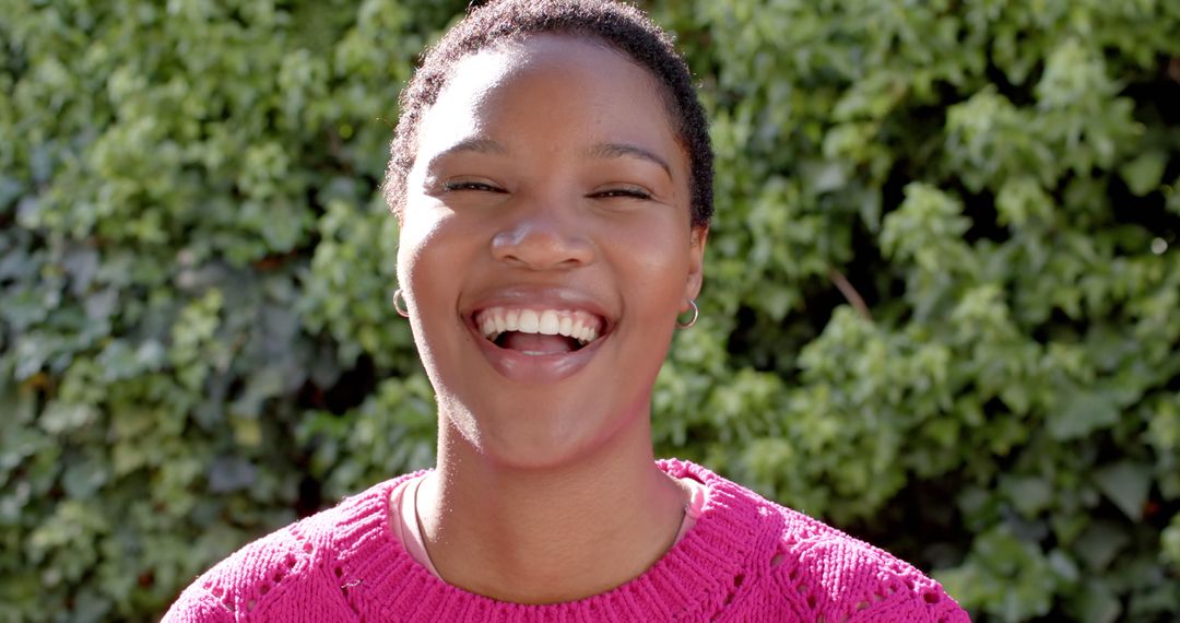 Smiling Woman in Pink Sweater Outdoors - Free Images, Stock Photos and Pictures on Pikwizard.com